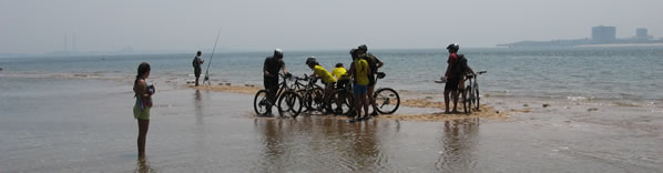 grupo de ciclistas na praia dentro de �gua